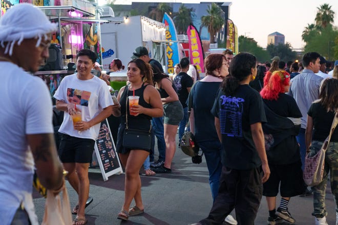 People crowd the streets of downtown Phoenix near Roosevelt Row for the First Friday art walk on Aug. 4, 2023.