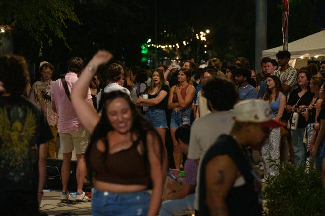 People dance and listen to a band play at the First Friday art walk in downtown Phoenix on Aug. 4, 2023.