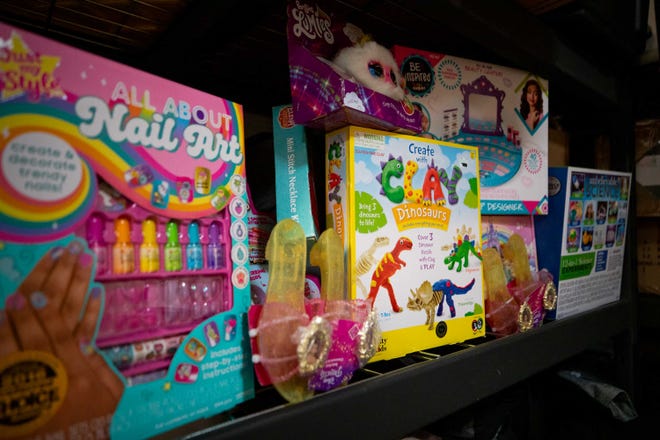 Toys line the shelves inside the Three Precious Miracles storage room in Sacaton on Nov. 30, 2023.