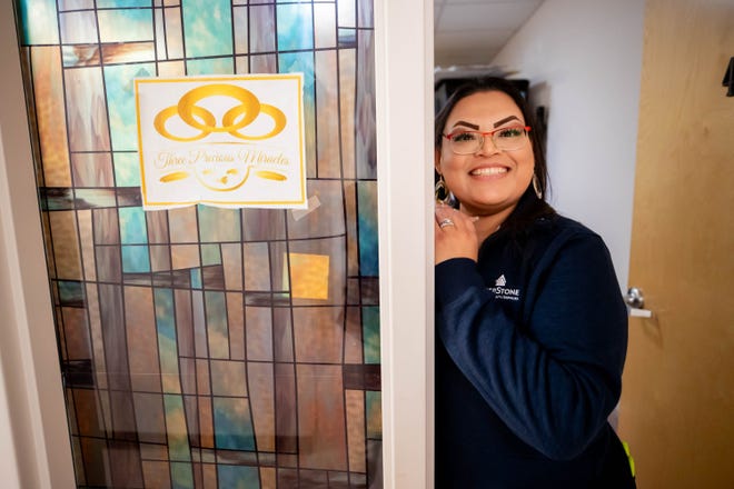 Elisia Manuel poses for a photo at the entrance of the Three Precious Miracles storage room in Sacaton on Nov. 30, 2023.