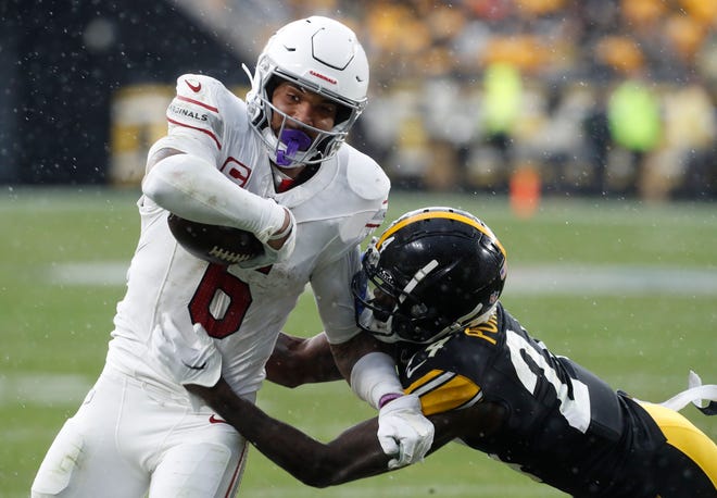 Arizona Cardinals running back James Conner (6) carries the ball against Pittsburgh Steelers cornerback Joey Porter Jr. (24) during the third quarter at Acrisure Stadium on Dec. 3, 2023.