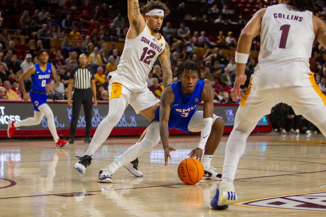 SMU's Chuck Harris (3) grabs the ball at Desert Financial Arena in Tempe on Dec. 6, 2023.