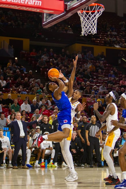 Zhuric Phelps (1) jumps up to shoot the basketball at Desert Financial Arena in Tempe on Dec. 6, 2023.
