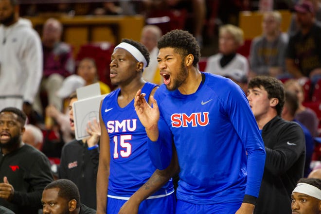 Southern Methodist University players cheer on their team from the sidelines at Desert Financial Arena in Tempe on Dec. 6, 2023.