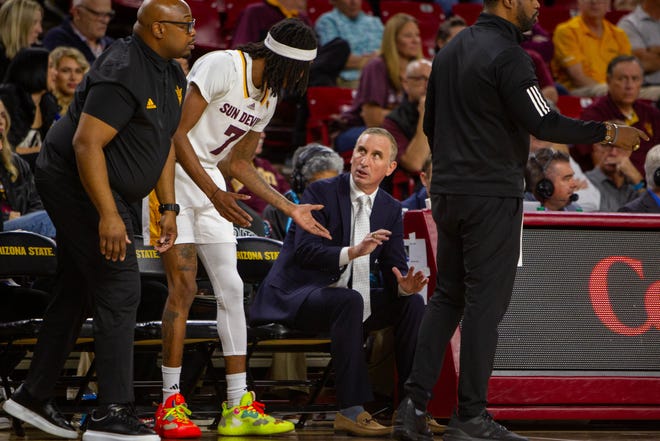 Head coach Bobby Hurley talks to Malachi Davis (7) on the sidelines at Desert Financial Arena in Tempe on Dec. 6, 2023.