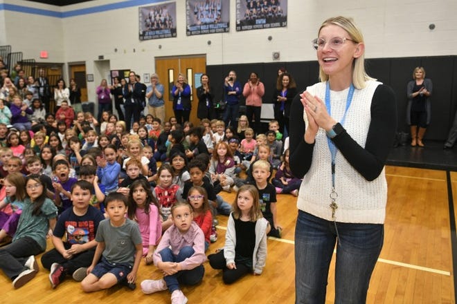 Horizon Honors Elementary School teacher Ashley Meyer makes her way to the front of the room on Dec. 7, 2023, after learning she is an Arizona Milken Educator and will receive a $25,000 check.