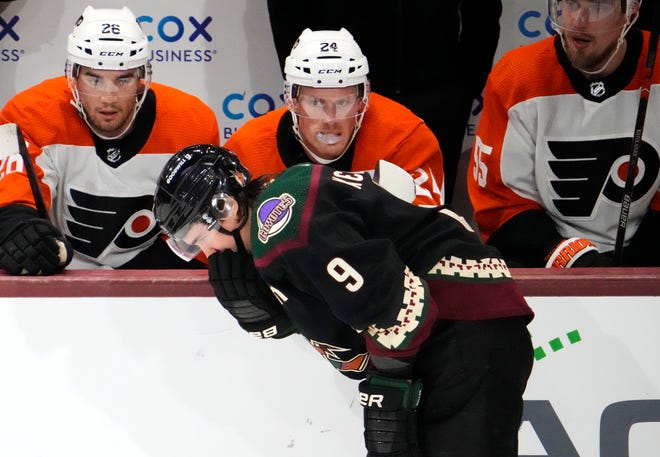 Arizona Coyotes right wing Clayton Keller (9) reacts after being high-sticked in the mouth by Philadelphia Flyers defenseman Travis Sanheim (6) in the first period at Mullett Arena.