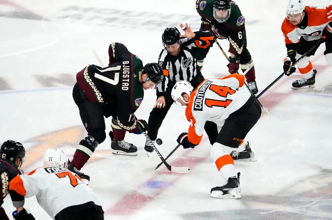 Arizona Coyotes center Nick Bjugstad (17) and Philadelphia Flyers center Sean Couturier (14) watch the puck drop to start the first period at Mullett Arena.