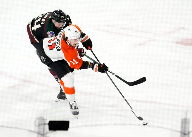 Philadelphia Flyers right wing Travis Konecny (11) scores a goal against Arizona Coyotes defenseman Matt Dumba (24) in the second period at Mullett Arena.