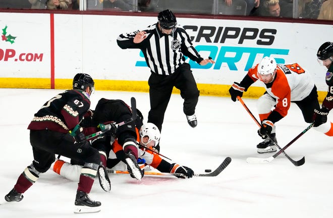 Arizona Coyotes center Nick Bjugstad (17) collides with Philadelphia Flyers center Scott Laughton (21) in the second period at Mullett Arena.
