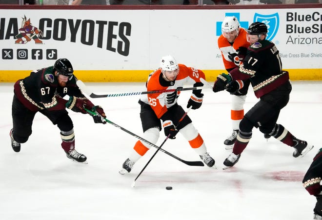 Arizona Coyotes left wing Lawson Crouse (67) and center Nick Bjugstad (17) pressure Philadelphia Flyers defenseman Sean Walker (26) in the third period at Mullett Arena.